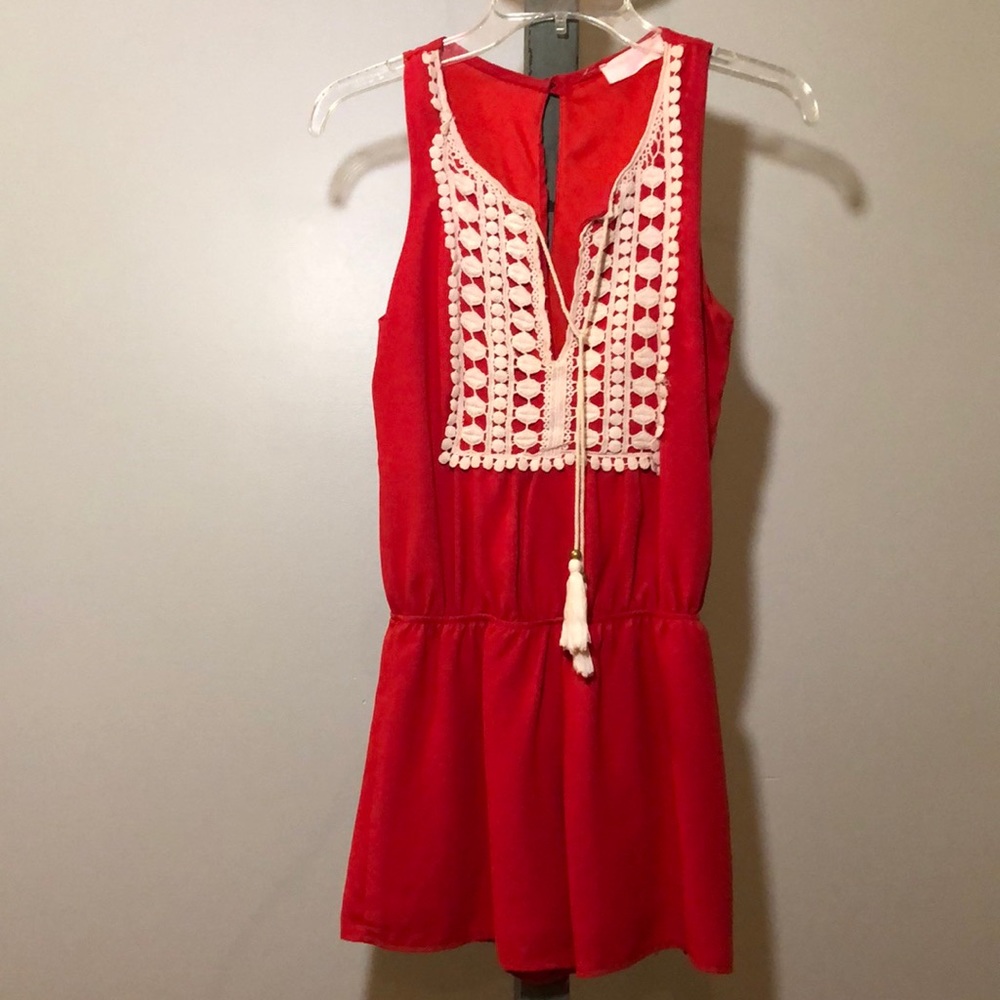 Sleeveless red romper.